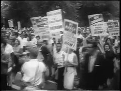 B/W August 28, 1963 large crowd with signs marching on wide street / March on Washington / newsreel Stock Footage