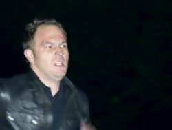 Man with gun running on street Stock Footage