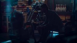 Man sitting in motorcycle workshop drinking coffe Stock Footage