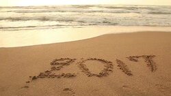 Concept: Drawing 2017 on the sand beach at end of year time Stock Footage