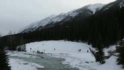 Pan down from mountains to hockey players Stock Footage