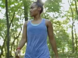 Young athletic woman running off road comes into view and rests, checking her watch Stock Footage