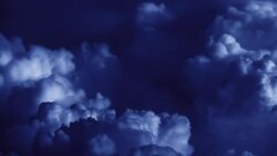 Dense clouds churn in an indigo sky. Stock Footage
