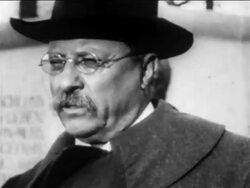 B/W 1900s close up Theodore Roosevelt in hat giving speech in front of monument / newsreel Stock Footage