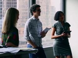 MS Group of coworkers standing in discussion at workstation in office/Washington, USA Stock Footage