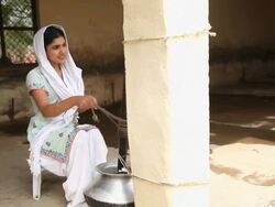 Woman extracting butter, Faridabad, Haryana, India  Stock Footage