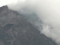Close up of steam and clouds swirling around Merapi volcano; Central Java, Indonesia. 28 October 2010 Stock Footage