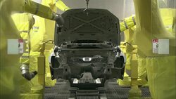Robot arms spray the interior of an auto body. Stock Footage