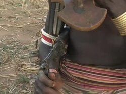 Medium hand-held - An Ethiopian man holds a rifle. / Ethiopia Stock Footage