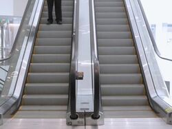  WS Businessman descending escalator in office building and walking away / Seattle, Washington, United States Stock Footage
