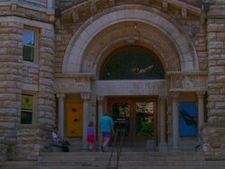 MS View of Natural History Museum, parent With  child entering, Celebrate Summer banner / Kansas, USA Stock Footage