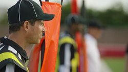 CU SLO MO. Football official referee stands on sideline with first down marker. Stock Footage