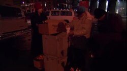 Homeless people receive aid and supplies from a social worker. Stock Footage
