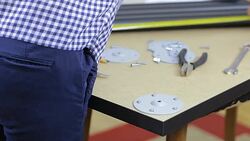 Young woman carpenter assembling the leg of her new furniture at home. Stock Footage