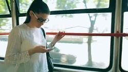 Female using smart phone while travel with public transportation. Stock Footage
