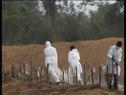 Mass burials of tsunami victims continue News Clip