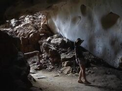 Female explorer is surveying the cave Stock Footage