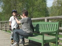 Father is checking the protected young skater Stock Footage