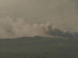 Smoke billows into the air from a lava flow burning vegetation, Philippines, Dec 2009 Stock Footage