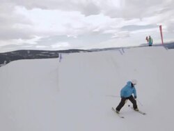 A skier doing a jumping trick on skis in the winter at a ski resort. - Slow Motion Stock Footage