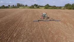 Tractor Ploughing Field, Aerial View Stock Footage