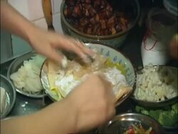 Breaking egg over pancake, Beijing, China Stock Footage