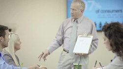 Older aged male leader presenting business ideas to his team Stock Footage