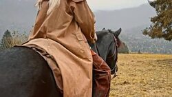 SLO MO Female rancher riding horse on mountain Stock Footage