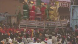 Costumed performers are held aloft as they move through a dense crowd during India's Diwali celebration. Stock Footage