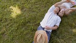 CS Young couple lying on the grass and making bubbles Stock Footage