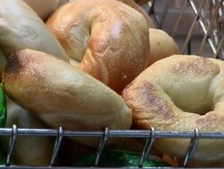 CU PAN Bagels including green ones for St Patricks day, for sale at street stall / New York, United States Stock Footage