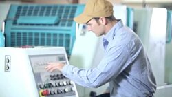 Man operating printing press, setting controls Stock Footage
