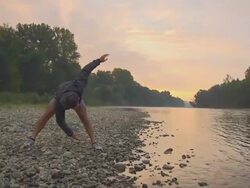 HD SLOW-MO: Athlete Stretching By The River Stock Footage