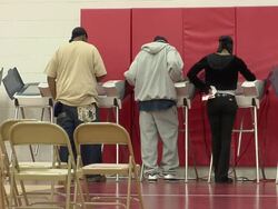 MS, Three people voting standing at electronic voting machines, Toledo, Ohio, USA Stock Footage