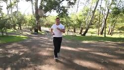 Young Man Running In The Forest Stock Footage