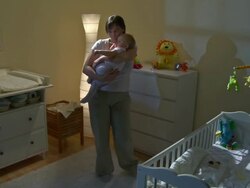 HD CRANE: Mother Taking Care Of Sleepless Baby Stock Footage