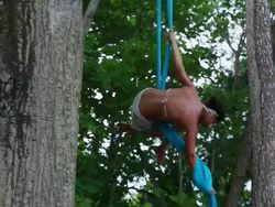 MS TS Woman hangs  spinning and dances hanging from material in trees in tropical environment / Montezuma, Puntarenas, Costa Rica Stock Footage
