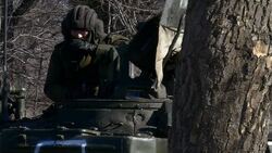 Pro Russian rebels stood around next to tank News Clip