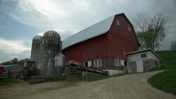 Red barn and grain silos on a dairy farm Stock Footage