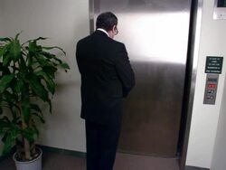 Wide shot businessman waiting for elevator/ getting into elevator with clown and superhero/ clown laughing/ low angle Stock Footage