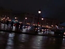 Wide shot side car point of view buildings, Luxor obelisk and ferris wheel at Place de la Concorde at night / Paris Stock Footage