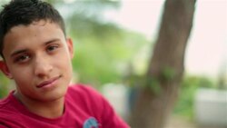 Hispanic teenager stares into camera Stock Footage