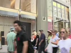 MS, Pedestrians passing by Bvlgari store window display, Fifth Avenue, New York City, New York, USA Stock Footage