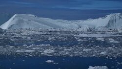 Ice flowing rapidly towards the sea, pan to Disko Bay Stock Footage