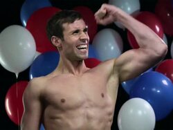 Man cheering and punching the air with balloons in background Stock Footage