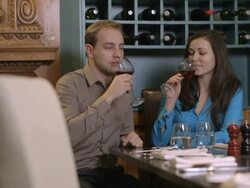 MS Couple drinking wine and flirting in restaurant Stock Footage