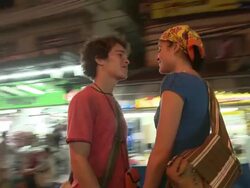 MS DS. Young couple on busy street at night, Bangkok, Thailand Stock Footage