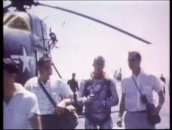 Astronaut Alan Shepard walking away from helicopter after splashdown Stock Footage