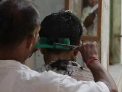 MH Rear View of Barber Giving Man Haircut / India Stock Footage