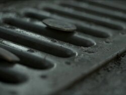 High Speed UK coins dropping onto drain Stock Footage